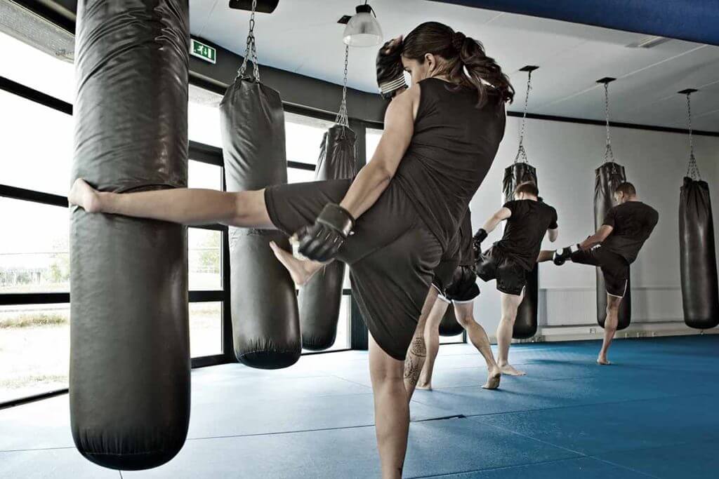 Group training on kicking heavy bags