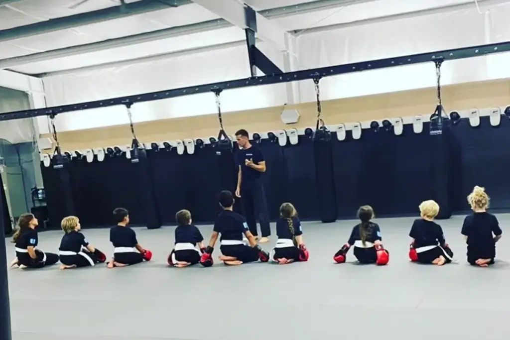 Coach Nolan teaching kickboxing class to kids.